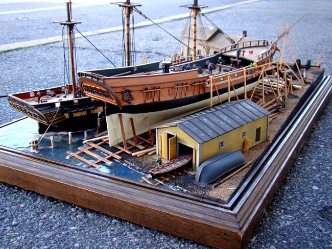 A fabulous and highly detailed scale model diorama circa 1920 of a New England Ship yard circa 1800-1812 making repairs on a 38 Gun American Frigate and a 10 Gun Privateer built circa 1785. — image 6
